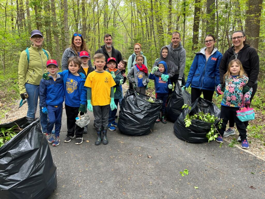 Volunteers with bags of vines cleared from trees